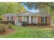 Brick ranch house with covered porch and mature landscaping at 520 Briar Creek Rd, Gastonia, NC 28056