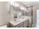 Double vanity bathroom with a large mirror and walk-in shower at 14913 Tamarack Dr, Charlotte, NC 28278