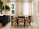 Bright dining room with wooden table, light-colored chairs, and large windows at 4476 Potter Wheel Dr, Fort Mill, SC 29715