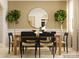 Dining room with a long wooden table, black chairs, and a large mirror at 4476 Potter Wheel Dr, Fort Mill, SC 29715