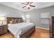 Main bedroom with wood platform bed and ceiling fan at 5621 Tipperlinn Way, Charlotte, NC 28278