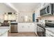 Modern kitchen with white cabinets, granite counters, and stainless steel appliances at 14034 Clayborn St # 28, Midland, NC 28107