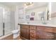 Double vanity bathroom with a walk-in shower and dark brown cabinets at 14034 Clayborn St # 28, Midland, NC 28107