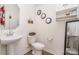 Clean bathroom with pedestal sink, toilet, and mirrored storage at 14034 Clayborn St # 28, Midland, NC 28107