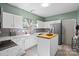 Modern kitchen with white cabinets, marble countertops, and a kitchen island at 239 Makayla Ct, Fort Mill, SC 29715