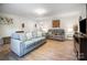 Living room with light teal couch and wood floors at 4127 Jacob Martin Dr, Charlotte, NC 28269