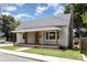 Updated home with gray siding, wood porch, and manicured lawn at 201 Mccubbins St, Salisbury, NC 28144