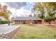 Large backyard with gravel area, mature trees, and a gas grill at 834 Brookwood Dr, Mooresville, NC 28115