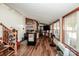 Open living area with hardwood floors, brick accent wall, and ample natural light at 834 Brookwood Dr, Mooresville, NC 28115