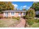 Brick ranch house with landscaped lawn, brick walkway, and a charming weepy tree at 834 Brookwood Dr, Mooresville, NC 28115