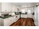 Kitchen with white cabinets, green countertops, and wood-look vinyl flooring at 834 Brookwood Dr, Mooresville, NC 28115