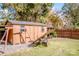 Large storage shed with double doors, windows, and a swing set nearby at 834 Brookwood Dr, Mooresville, NC 28115