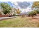 Large backyard with gravel area, mature trees, and a gas grill at 834 Brookwood Dr, Mooresville, NC 28115