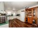 Bright eat-in kitchen with white cabinets, green countertops, and wood flooring at 834 Brookwood Dr, Mooresville, NC 28115