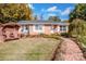 Brick ranch house with landscaped lawn, brick walkway, and a charming wooden arbor at 834 Brookwood Dr, Mooresville, NC 28115