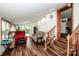 Cozy living room with hardwood floors, comfy seating, and access to outdoor space at 834 Brookwood Dr, Mooresville, NC 28115