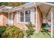 Brick house with covered side entrance, green artificial turf, and a small bench at 834 Brookwood Dr, Mooresville, NC 28115