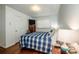 Comfortable bedroom featuring a plaid comforter and wood flooring at 834 Brookwood Dr, Mooresville, NC 28115