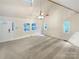 Bright living room with vaulted ceiling and carpeting at 1259 Blacksnake Rd, Stanley, NC 28164
