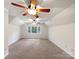 Large bedroom with ceiling fan and neutral carpeting at 1259 Blacksnake Rd, Stanley, NC 28164