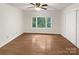 Bedroom with hardwood floors and a view of the woods at 1259 Blacksnake Rd, Stanley, NC 28164