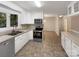 White kitchen with stainless steel appliances and tile flooring at 1259 Blacksnake Rd, Stanley, NC 28164