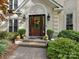 Elegant front door entry with brick steps and autumnal decor at 112 N Sardis View Ln, Charlotte, NC 28270