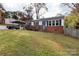 Brick ranch home with carport, landscaping, and fenced yard at 503 Cherry St, Belmont, NC 28012