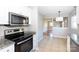 Kitchen with stainless steel appliances and view into the living room at 503 Cherry St, Belmont, NC 28012