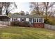 Brick ranch home with carport, landscaping, and fenced yard at 503 Cherry St, Belmont, NC 28012