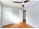 Bright bedroom with hardwood floors, double doors, and ceiling fan at 503 Cherry St, Belmont, NC 28012