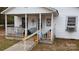 Quaint front porch with rocking chair and ramp access at 7614 Secrest Short Cut Rd, Indian Trail, NC 28079