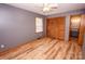 Gray bedroom with wood-look flooring, ceiling fan, and closet with louvered doors at 539 Bethlehem Rd, Statesville, NC 28677