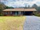 Front exterior view of a one-story brick house with a carport and gravel driveway at 539 Bethlehem Rd, Statesville, NC 28677