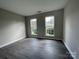 Spacious bedroom with two windows and grey flooring at 12011 Creek Turn Dr, Charlotte, NC 28278