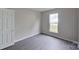 Well-lit bedroom with grey flooring and a closet at 12011 Creek Turn Dr, Charlotte, NC 28278