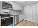 Modern kitchen features stainless steel appliances and white shaker cabinets at 3925 Phelps Rd, Vale, NC 28168