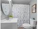 Updated bathroom with white vanity, round mirror and shower at 3925 Phelps Rd, Vale, NC 28168