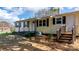 Front view of yellow ranch home with black shutters and steps at 3925 Phelps Rd, Vale, NC 28168