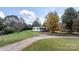 Ranch home with yard, driveway, and mature trees at 3925 Phelps Rd, Vale, NC 28168