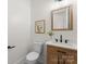 Modern powder room with wood vanity, quartz countertop, and black matte fixtures at 108 Augusta Ln, Shelby, NC 28150
