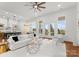 Open concept living area with white sofa and chairs, and views into kitchen and dining areas at 108 Augusta Ln, Shelby, NC 28150