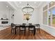 Open concept dining room with chandelier and large windows offering natural light at 108 Augusta Ln, Shelby, NC 28150