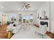 Bright living room with white slipcovered furniture, fireplace, and access to outdoor patio at 108 Augusta Ln, Shelby, NC 28150