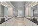 Elegant bathroom with double vanities, a large soaking tub, and a walk-in shower at 102 Eastham Ct, Mooresville, NC 28117