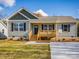 Newly built home with light grey siding, wood-toned porch and driveway at 1331 Old Salisbury Rd, Statesville, NC 28625