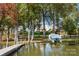 Lakefront dock with boat slip and surrounding trees at 25566 Seagull Dr, Lancaster, SC 29720