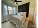 Bright bedroom with a bed, large windows, and a dark accent wall at 221 Sutton Park Ln # 10, Charlotte, NC 28211