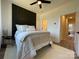 Charming bedroom with a queen bed, dark accent wall, and access to a hallway at 221 Sutton Park Ln # 10, Charlotte, NC 28211