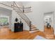 Elegant entryway with curved staircase and hardwood floors at 2034 Iverson Ln, Waxhaw, NC 28173